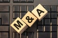 M A - acronym from wooden blocks with letters, concept. M and A - Mergers and Acquisitions Royalty Free Stock Photo