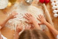 Mother and her kids kneading dough on kitchen table Royalty Free Stock Photo