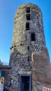 MÃ¼hlenturm Schloss Liedberg. Old historic stone tower in a German village. Remains of an old castle or city wall. A woman with a Royalty Free Stock Photo