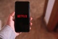 MÃLAGA - SPAIN - APRIL 6, 2023: Woman streaming Netflix on smartphone.