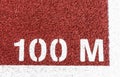 100 M painted white on a red track Royalty Free Stock Photo