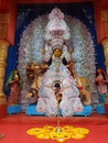 Maa Jagadhatri , one from of Durga ,in a well decorated pandal ,with a flower decoration and a holy lamp infront her.