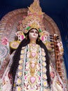 Maa saraswati , a hindu goddess at puja pandal with two swans and a veena with a blue background