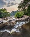 Maak Ngaew Waterfalls and cascades running through tropical forest,at sunset, near Pakse,Laos