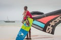 Maasai on the beach in Kenya Diani beach and Watamu holding a kite and a kite board kiteboarding staff Royalty Free Stock Photo