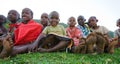 Maasai children sit together on the ground. Kenya