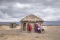 Maasai family outside their home