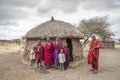 Maasai family outside their home