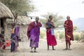 Maasai family outside thier home