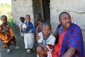 Maasai family at threshold of his house, father and children.