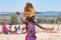 Maasai man, warrior, typical garb and male lion mane on head, spear in hand, Tanzania Royalty Free Stock Photo