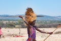 Maasai man, warrior, typical garb and male lion mane on head, spear in hand, Tanzania Royalty Free Stock Photo