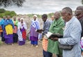 Maasai people reading Bible and worship God