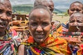 Maasai woman with traditional jewelry selling homemade souvenirs