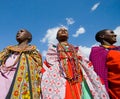 Maasai women together singing ritual songs in traditional dress.