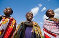 Maasai women together singing ritual songs in traditional dress.