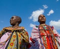 Maasai women together singing ritual songs in traditional dress.