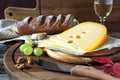Maasdam cheese, bread, grapes and wineglass Royalty Free Stock Photo