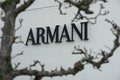 Armani trademark sign, through a tree at Maasmechelen village outlet Royalty Free Stock Photo