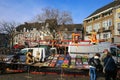 View on flea market stand on historic square, old bildings background against blue winter sky Royalty Free Stock Photo