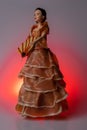 Food art image. The doll is dressed up with Spanish Iberico Ham, which looks like a flamenco dress and using a fan of manchego che