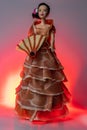 Food art image. The doll is dressed up with Spanish Iberico Ham, which looks like a flamenco dress and using a fan of manchego che