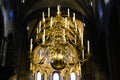 Low angle view on golden chandelier with candles under dome of romanesque catholic church Basiliek van Onze-Lieve-Vrouw-Tenhemel