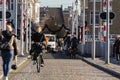 MAASTRICHT, NETHERLANDS - NOVEMBER 10, 2022: People biking on Sint Servaasbrug bridge in Maastricht city center. Netherlands are