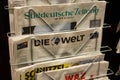 View on rack with isolated german daily newspapers. Focus on `Die Welt