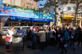 People enjoying fresh fried Kibbeling, fried fish at the market in Maastricht Royalty Free Stock Photo