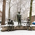 Snowfall over Maastricht with the statue of Fons Olterdissen covered with sno