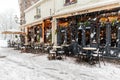 Snowfall over Maastricht with a view on empty terrace covered with snow Royalty Free Stock Photo
