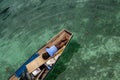 A family of "Bajau Laut" with the small boat, floating on the blue ocean