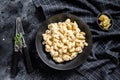 Mac and cheese. American style macaroni pasta in cheesy sauce. Black wooden background. Top view Royalty Free Stock Photo