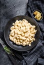 Mac and cheese. American style macaroni pasta in cheesy sauce. Black wooden background. Top view Royalty Free Stock Photo