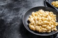 Mac and cheese. American style macaroni pasta in cheesy sauce. Black wooden background. Top view. Copy space Royalty Free Stock Photo