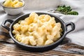 Mac and cheese, american style macaroni pasta in cheesy sauce. White wooden background. Top view Royalty Free Stock Photo