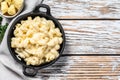 Mac and cheese, american style macaroni pasta in cheesy sauce. White wooden background. Top view. Copy space Royalty Free Stock Photo