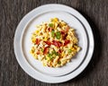 mac and cheese with corn, bacon topped with panko breadcrumbs on plate