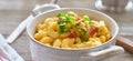 Mac and cheese in dish with scallions and bacon garnish Royalty Free Stock Photo