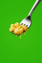 mac and cheese on a fork over green, generative AI Royalty Free Stock Photo