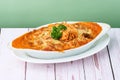 Mac and cheese, Italian style Baked Pasta Kimchi Cream in cheesy sauce in white plate on wooden table Royalty Free Stock Photo