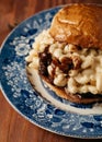 Mac and Cheese sandwich with brisket and bbq sauce on a blue vintage plate Royalty Free Stock Photo