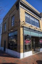 Macâs Chophouse with a red brick sidewalk lined with shops, restaurants and bars with tables and chairs on the sidewalk Royalty Free Stock Photo