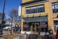 Macâs Chophouse with a red brick sidewalk lined with shops, restaurants and bars with tables and chairs on the sidewalk