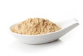 Maca powder in white porcelain spoon