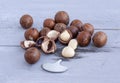 Macadamia is an Australian nut, a Kindal. On a wooden fob is a gray-blue color Royalty Free Stock Photo