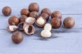 Macadamia is an Australian nut, a Kindal. On a wooden fob is a gray-blue color Royalty Free Stock Photo