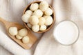 The Macadamia milk in glass and a bowl of macadamia on tablecloth