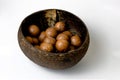 Macadamia nut in a handmade cup of coconut shell on a white background Royalty Free Stock Photo